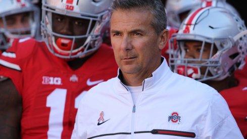 Urban Meyer leads his team on the field against Indiana. 