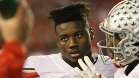 Curtis Samuel gets instructions from a coach during the Wisconsin game.