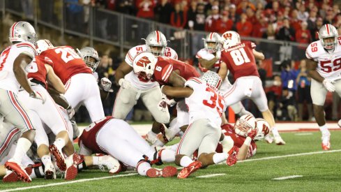 Chris Worley tackles Wisconsin RB Corey Clement.