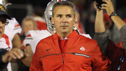 Urban Meyer leads Ohio State onto the field at Wisconsin. 