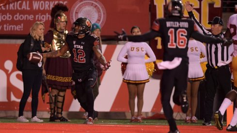 Sep 23, 2016; Salt Lake City, UT, USA; Utah Utes wide receiver Tim Patrick (12) celebrates with wide receiver Cory Butler-Byrd (16) after catching an 18-yard touchdown pass with 16 seconds left for the winnning score against the USC Trojans during a NCAA football at Rice-Eccles Stadium. Utah defeated USC 31-27. Mandatory Credit: Kirby Lee-USA TODAY Sports