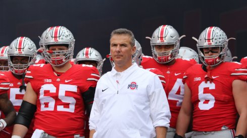 Urban Meyer leads Ohio State onto the field vs. Northwestern. 