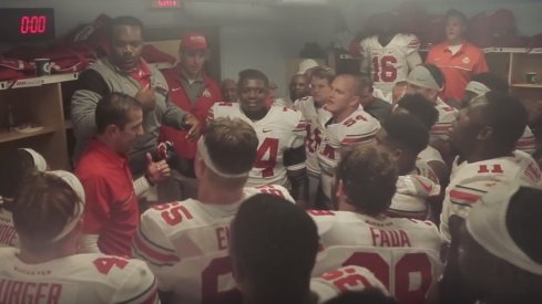 Larry Johnson and Coach Fickell lead the troops after beating Wisconsin.