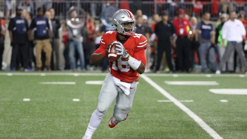 J.T. Barrett rolls out to pass earlier this season.