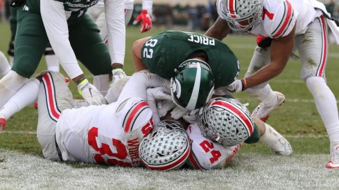 Malik Hooker and Chris Worley pick off a two-point conversion against Michigan State. 