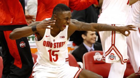 Ohio State's Kam Williams celebrates on the bench. 