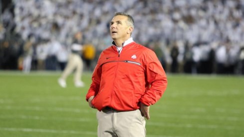 Urban Meyer looks at a replay during a game.