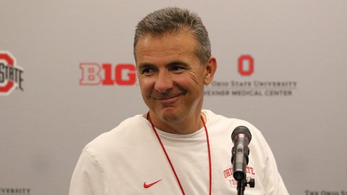 Urban Meyer talks to media.