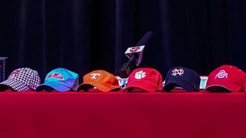 Hats sit on a table prior to five-star offensive tackle Trey Smith's announcement