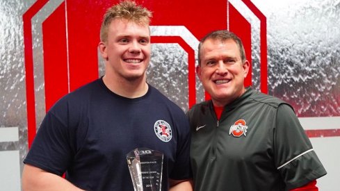 Ohio State lineman Pat Elflein and Ed Warinner pose with Elflein's Big Ten trophy.