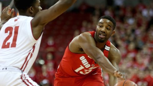 Ohio State point guard JaQuan Lyle makes a pass at Wisconsin. 