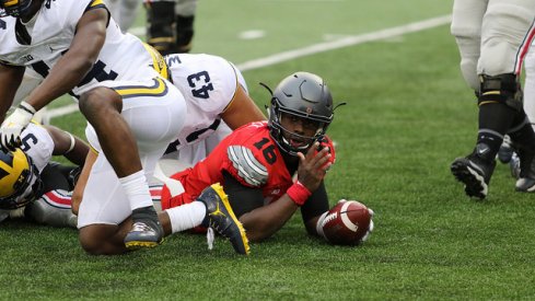 J.T. Barrett earns a first down against Michigan.