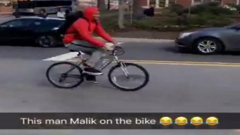 Ohio State footballer Malik Harrison riding a bike.