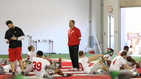 New linebackers coach Bill Davis watches his players warm up.