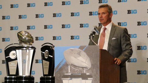 Ohio State coach Urban Meyer and the Big Ten trophies. 