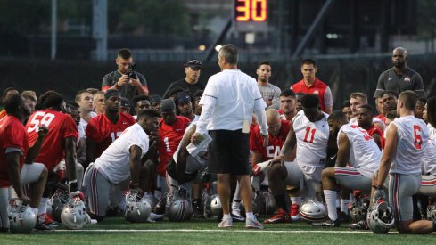 Urban Meyer talks to his team during its first preseason practice on July 27.