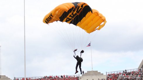 Army members parachute into the Horseshoe leading up to today's kickoff. 