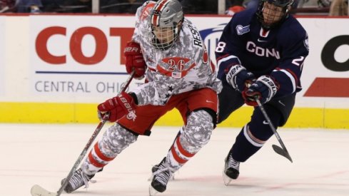 Ohio State's Mason Jobst battles battles a Connecticut Huskies player in a men's hockey game at Value City Arena. 