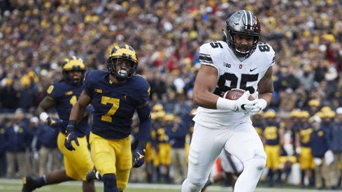 Marcus Baugh scores against Michigan.