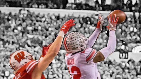 Dec 2, 2017; Indianapolis, IN, USA; Ohio State Buckeyes cornerback Denzel Ward (12) intercepts the ball while Wisconsin Badgers tight end Troy Fumagalli (81) defends in the first half in the Big Ten championship game at Lucas Oil Stadium. Mandatory Credit: Trevor Ruszkowski-USA TODAY Sports