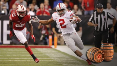 Dec 2, 2017; Indianapolis, IN, USA; Ohio State Buckeyes running back J.K. Dobbins (2) attempts to stay in bounds as he is chased by Wisconsin Badgers cornerback Derrick Tindal (25) in the third quarter in the Big Ten championship game at Lucas Oil Stadium. Mandatory Credit: Mark Hoffman/Milwaukee Journal Sentinel via USA TODAY Sports