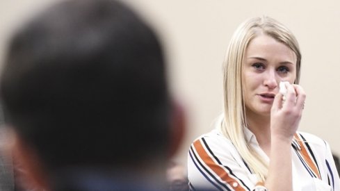 Jan 18, 2018; East Lansing, MI, USA; MSU student and former gymnast Christine Harrison addresses Larry Nassar during her victim impact statement in Circuit Judge Rosemarie Aquilina's courtroom, the third day of testimonials concerning the former sports medicine doctor who pled guilty to seven counts of sexual assault in Ingham County, and three in Eaton County. At her side is Larry Harrison, her dad, a retired Det. Sgt. with the Ingham County Sheriff's Department. Mandatory Credit: Matthew Dae Smith/Lansing