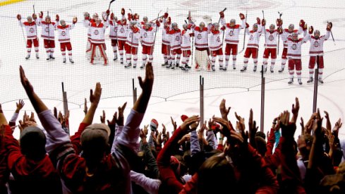 Ohio State men's hockey celebrates a win with the Buckeye students.