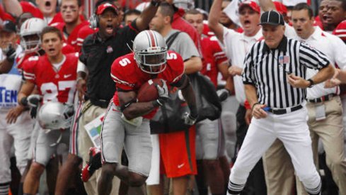 Chimdi Chekwa intercepts a pass against Miami in 2010 with Taver Johnson cheering in the background.