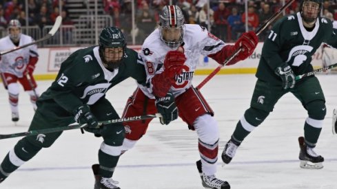 Dakota Joshua leads a Buckeye charge against the Michigan State Spartans.