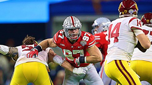 Dec 29, 2017; Arlington, TX, USA; Ohio State Buckeyes defensive end Nick Bosa (97) applies pressure in the second quarter against Southern California Trojans quarterback Sam Darnold (12) in the 2017 Cotton Bowl at AT&T Stadium.