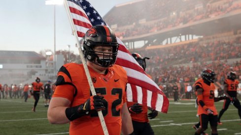 Oct 26, 2017; Corvallis, OR, USA; Oregon State Beavers offensive lineman Sumner Houston (52) carries the American Flag onto the field before the game against the Stanford Cardinal at Reser Stadium. Mandatory Credit: Scott Olmos-USA TODAY Sports