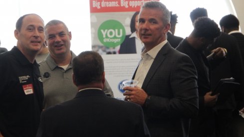 Urban Meyer chats with director of football operations Brian Voltolini and car dealer George Kauffman at the Ohio State Job Fair.