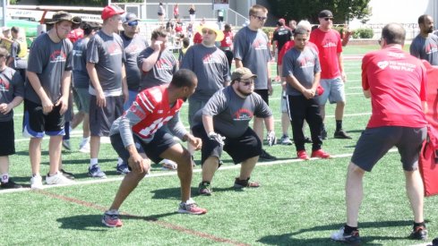 Keandre Jones coaches a participant at the Special Skills Football Invitational.