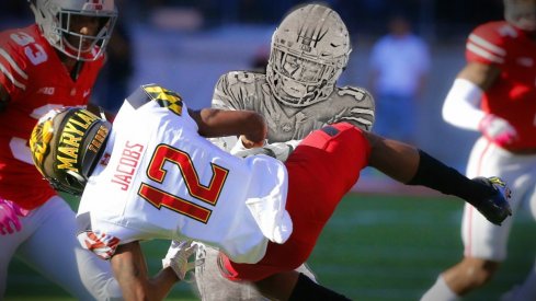 Oct 7, 2017; Columbus, OH, USA; Ohio State Buckeyes cornerback Denzel Ward (12) lays the hit on Maryland Terrapins wide receiver Taivon Jacobs (12) which jarred the ball loose and got Ward ejected during the first half at Ohio Stadium. Mandatory Credit: Joe Maiorana-USA TODAY Sports