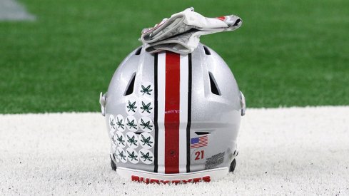 An Ohio State helmet sits on the field at AT&T Stadium.