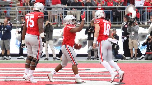 Thayer Munford, J.K. Dobbins and Tate Martell celebrate a Dobbins touchdown.