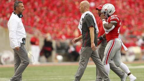 Mike Weber limps off the field after suffering an injury against Tulane on Saturday.