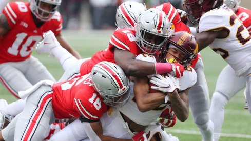 Oct 13, 2018; Columbus, OH, USA; Minnesota Golden Gophers wide receiver Demetrius Douglas (82) is tackled by Ohio State Buckeyes linebacker Dallas Gant (19) and linebacker Keandre Jones (16) during the second quarter at Ohio Stadium. Mandatory Credit: Joe Maiorana-USA TODAY Sports