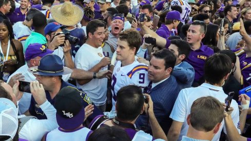 Oct 13, 2018; Baton Rouge, LA, USA; LSU Tigers quarterback Joe Burrow (9) is guided to the locker room after the game win against Georgia Bulldogs at Tiger Stadium. Mandatory Credit: Stephen Lew-USA TODAY Sports