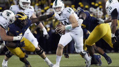 Brian Lewerke escapes the Michigan defensive line