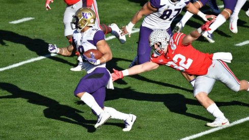 Myles Gaskin runs past Tuf Borland in the Rose Bowl. 