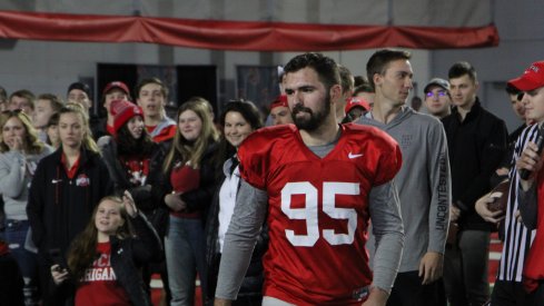 Kicker Blake Haubeil helps out a student hoping to win free Chick-Fil-A for a year. 