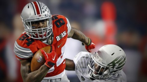 Ohio State Buckeyes wide receiver Corey Smith (84) gets away from Oregon Ducks defensive back Reggie Daniels (8) after making a pass during the 2nd quarter in College Football Playoff Championship game at AT&T Stadium in Arlington, Texas on January 12, 2015. Smith then fumbles the ball and loses it to Oregon Ducks. (Dispatch photo by Kyle Robertson)