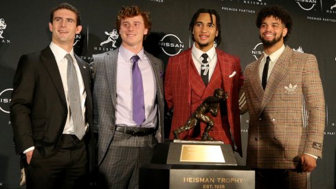 The Heisman Trophy finalists pose with the trophy.