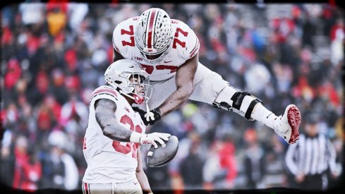 Nov 19, 2022; College Park, Maryland, USA; Ohio State Buckeyes running back TreVeyon Henderson (32) celebrates with offensive lineman Paris Johnson Jr. (77) after scoring a first quarter touchdown against the Maryland Terrapins at SECU Stadium. 