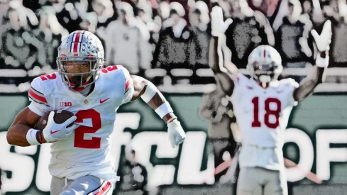 Oct 8, 2022; East Lansing, Michigan, USA; Ohio State Buckeyes wide receiver Emeka Egbuka (2) heads up field and scores after a catch in the first quarter of the NCAA Division I football game between the Ohio State Buckeyes and Michigan State Spartans at Spartan Stadium.