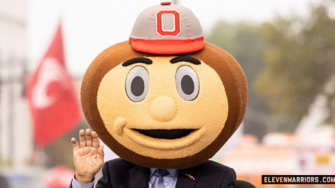 Lee Corso of ESPN's College GameDay wearing a Brutus Buckeye helmet.