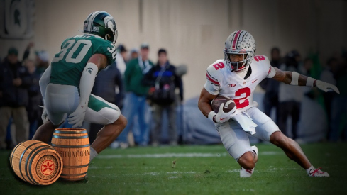 Oct 8, 2022; East Lansing, Michigan, USA; Ohio State Buckeyes wide receiver Emeka Egbuka (2) heads up field after a catch against Michigan State Spartans cornerback Justin White (30) in the second quarter of the NCAA Division I football game between the Ohio State Buckeyes and Michigan State Spartans at Spartan Stadium.