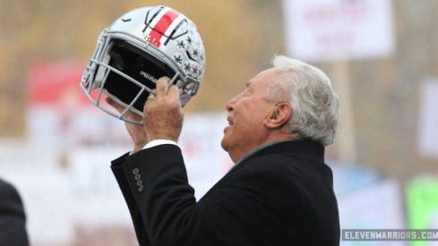 Lee Corso lifts Ohio State helmet on the set of ESPN's College GameDay