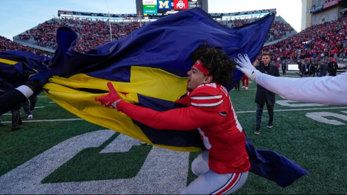 Miles Lockhart tears down the Michigan flag